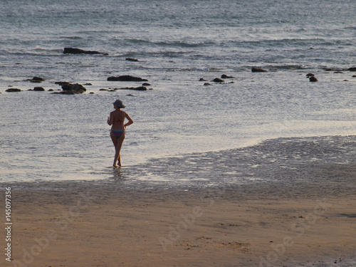 Mujer paseando en la playa de Zahora / Woman walking on Zahora beach. Cádiz photo
