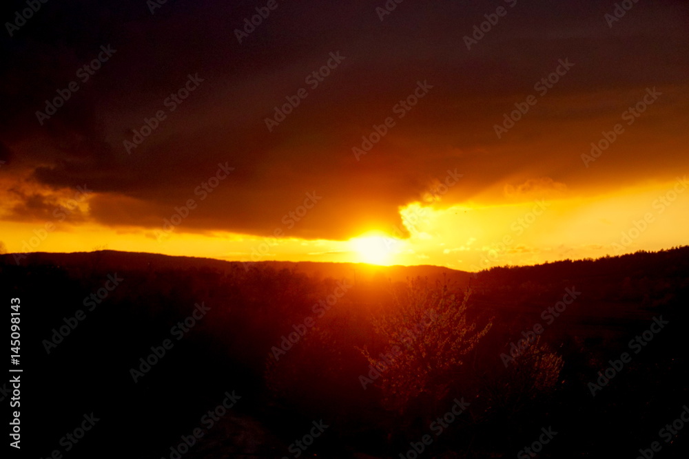 sunset landscape small mountain with clouds in the sky red