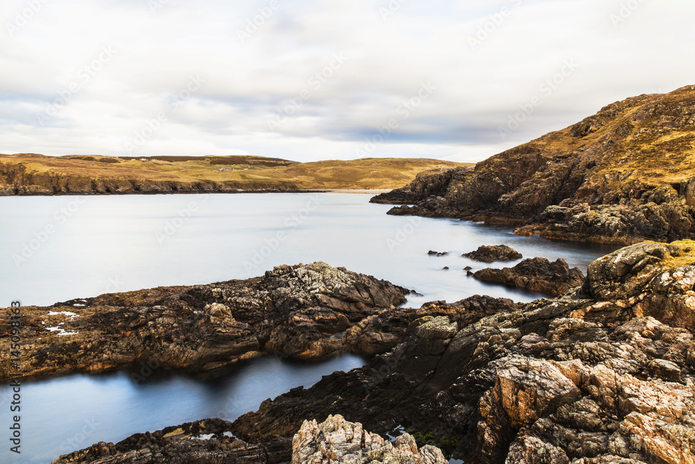 Rocks on the coast at Farr Bay beach in Sutherland, Scotland.