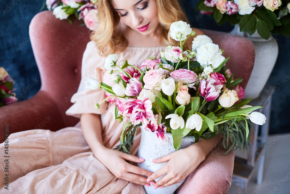 Portrait of a young beautiful woman with spring flowers