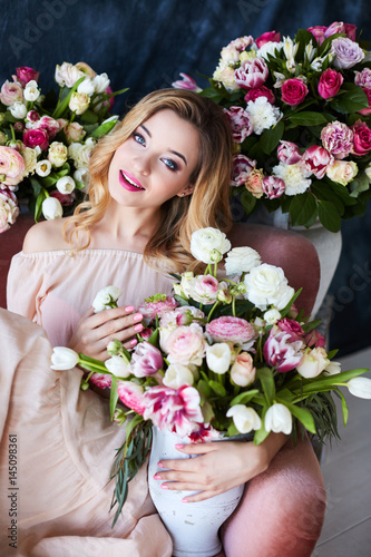 Portrait of a young beautiful woman with spring flowers