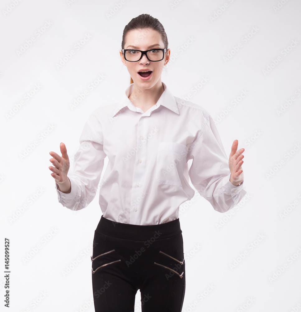 Young happy woman showing presentation, pointing on placard over gray background Young happy woman showing presentation, pointing on placard over gray background