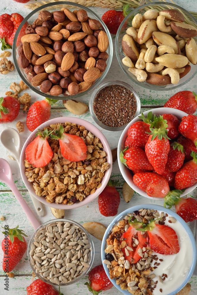 Muesli, nuts, yogurt and cereals on a white background Muesli, nuts, yogurt and cereals on a white background