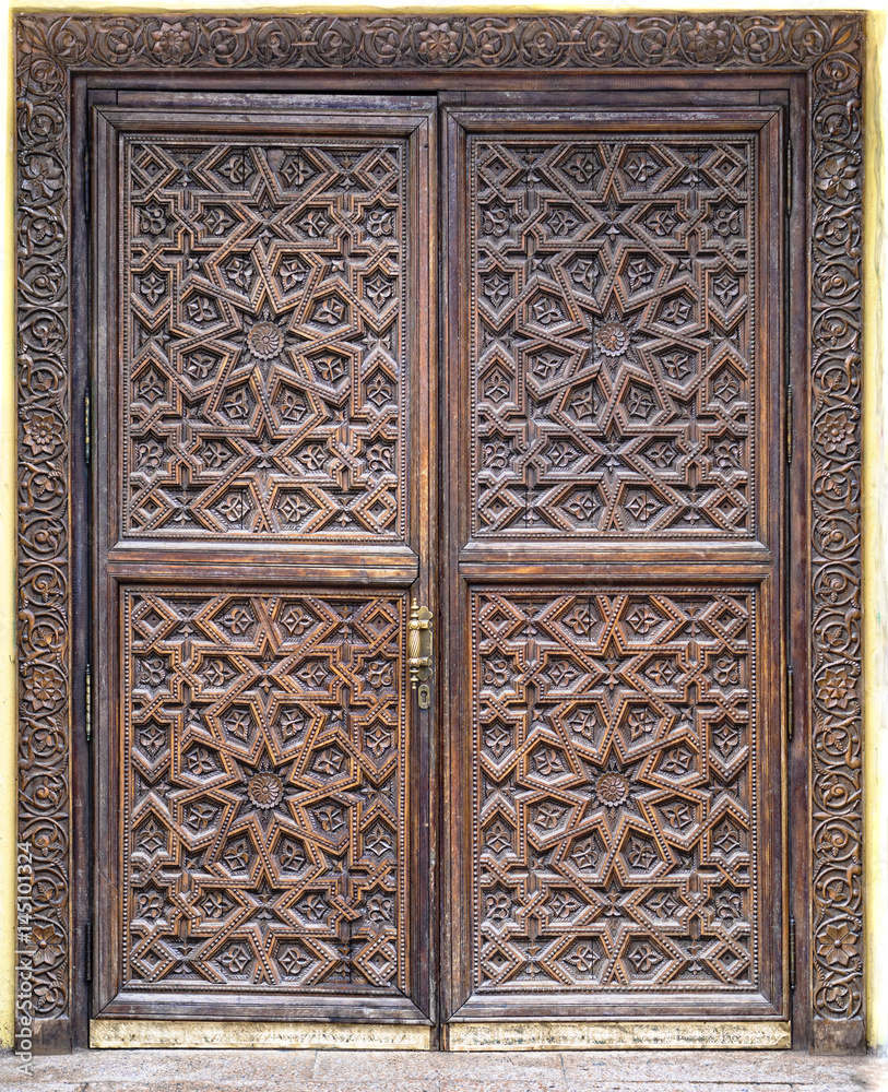 old wooden door with beautiful carved pattern