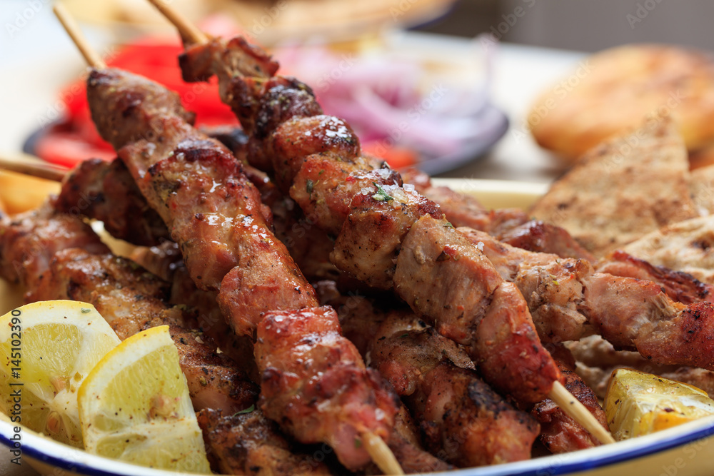 Grilled meat skewers in a dish