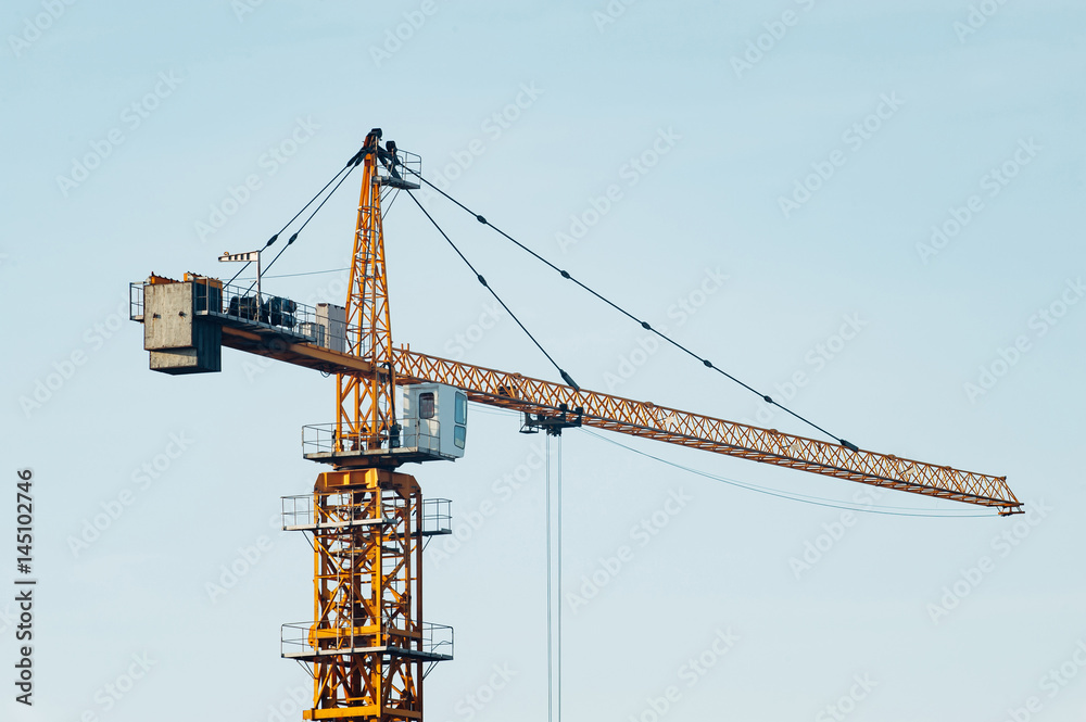 Crane on a blue clear sky background. Industry. Isolated.