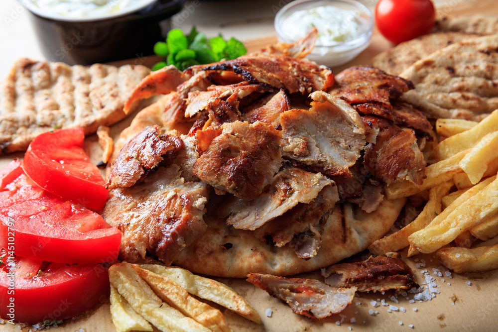 Greek gyros dish on baking paper Greek gyros dish on baking paper
