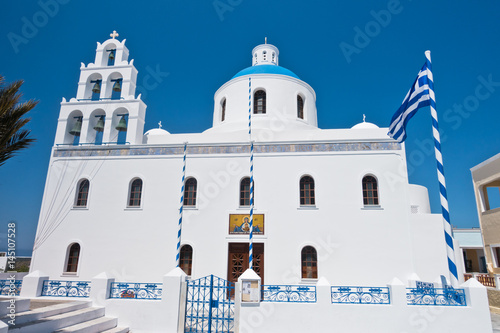 Panagia church with blue dome and big bell tower at Oia village, Santorini island, Greece