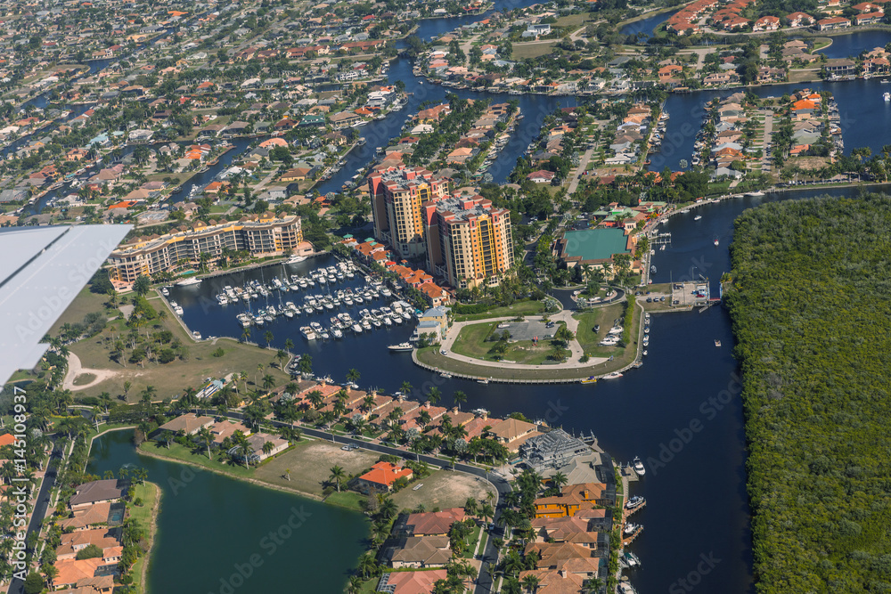 Fototapeta premium Aerial view of city and gulf Cape Coral, Florida. The Westin Cape Coral Resort at Marina Village