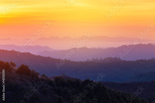 high view sunrise in early morning over rainforest with layer mountain in thailand 