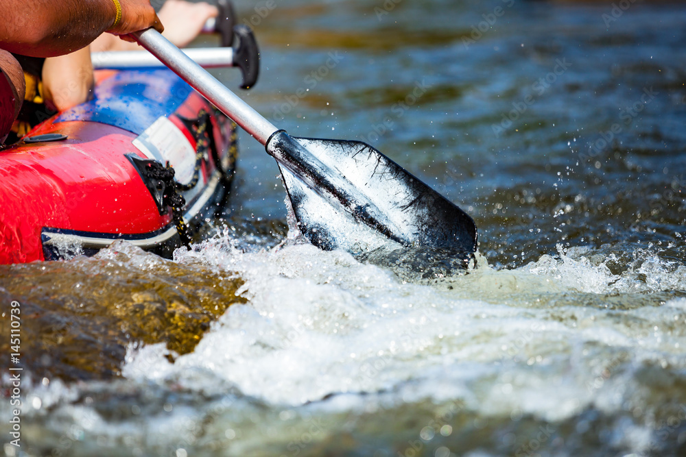 Naklejka premium Focus some part of young person are rafting in river.