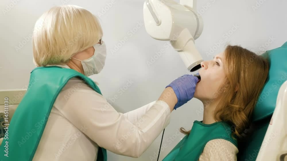 digital system equipment for dental diagnostic examination with patient woman in protective clothes 4k digital system equipment for dental diagnostic examination with patient woman in protective clothes 4k