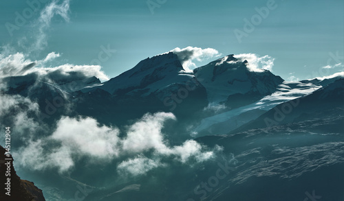 Snow capped mountains. Summits of the mountains. View of the Alpine mountains at the sunrise. Trek near Matterhorn mount.