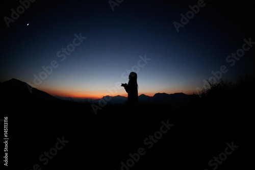 sunset silhouette  young lady in hill