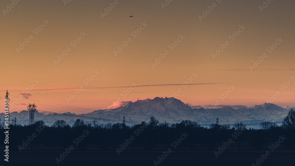 Naklejka premium airplane over the mountains - italian alps - travel concept