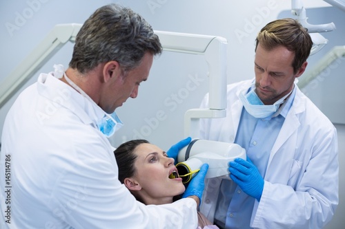 Dentists taking x-ray of patients teeth