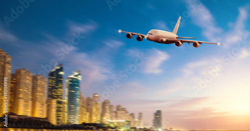 Front view of commercial airplane, blur modern city on background