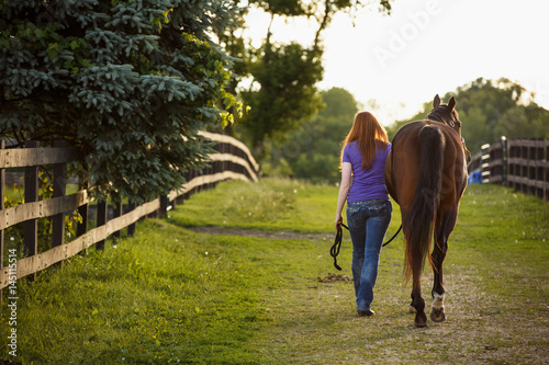 Girl and horse walking side by side