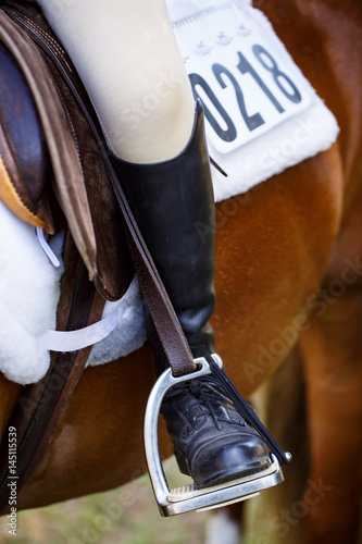 Close up of riders leg/boot in stirrup