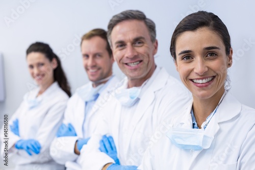 Smiling dentists standing with arms crossed photo