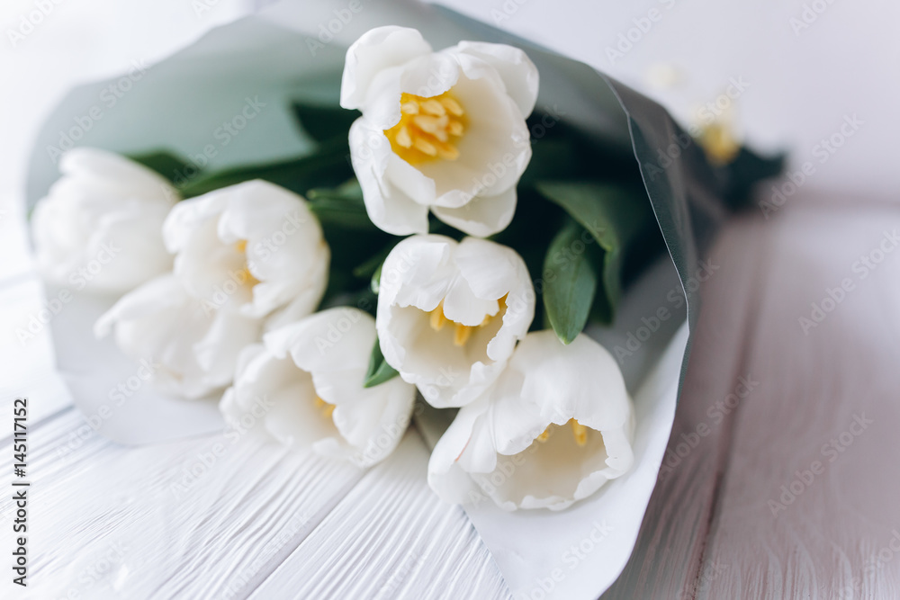 Mother's Day . white tulips on white wooden background Mother's Day . white tulips on white wooden background