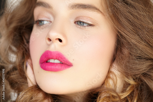 Close-up portrait of beautiful girl with pink lips