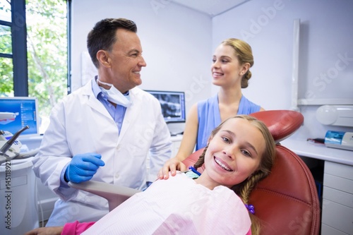 Dentist interacting with young patients mother