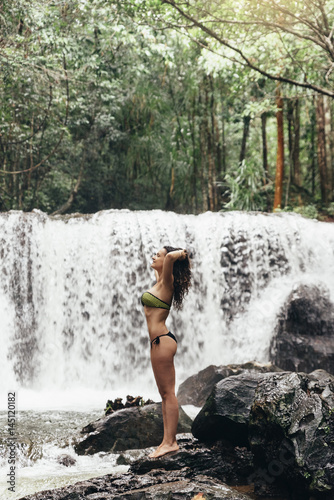 Female model in nature waterfall.