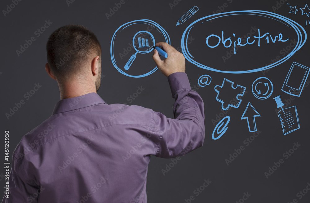 Business, Technology, Internet and network concept. A young businessman writes on the blackboard the word: Objective Business, Technology, Internet and network concept. A young businessman writes on the blackboard the word: Objective