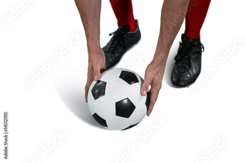 Football player placing football