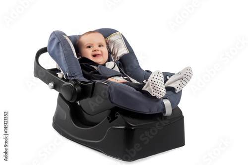 Smiling infant baby child sitting in a car seat, isolated on white