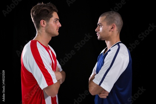 Quadro em tela Two rival football player looking at each other
