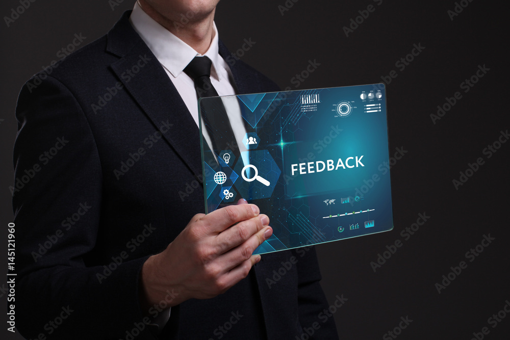 Business, Technology, Internet and network concept. Young businessman working on a virtual screen of the future and sees the inscription: Feedback Business, Technology, Internet and network concept. Young businessman working on a virtual screen of the future and sees the inscription: Feedback