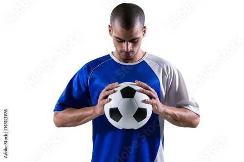 Football player holding football with both hands