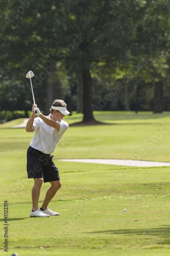 Male golfer preparing to swing