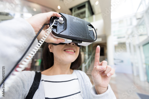 Woman using VR device photo