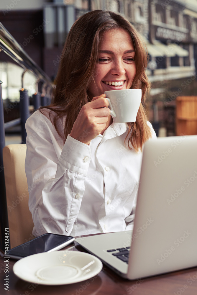 Appealing smiling businesswoman using laptop Appealing smiling businesswoman using laptop