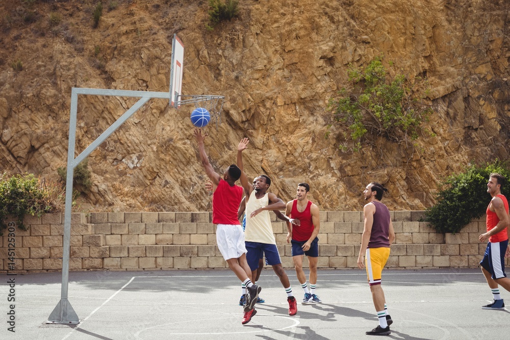 Basketball players playing basketball in the court Basketball players playing basketball in the court