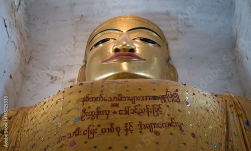 Buddha statue in Manuha Temple, Bagan, Myanmar photo