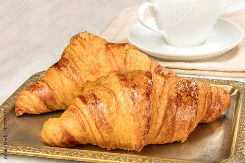 Fresh croissants on vintage tray, with copyspace