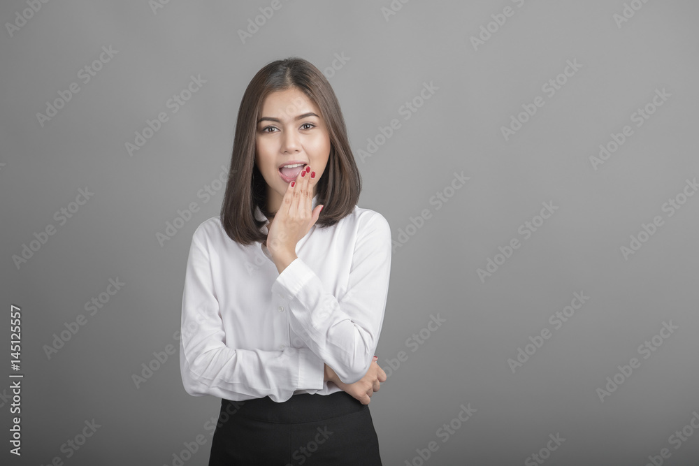 Beautiful Business Woman surprised with something on grey background Beautiful Business Woman surprised with something on grey background