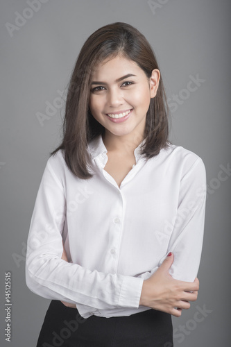 Beautiful Business Woman smiling on grey background
