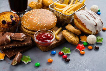 Assortment of unhealthy products that's bad for figure, skin, heart and teeth. Fast carbohydrates food. Space for text