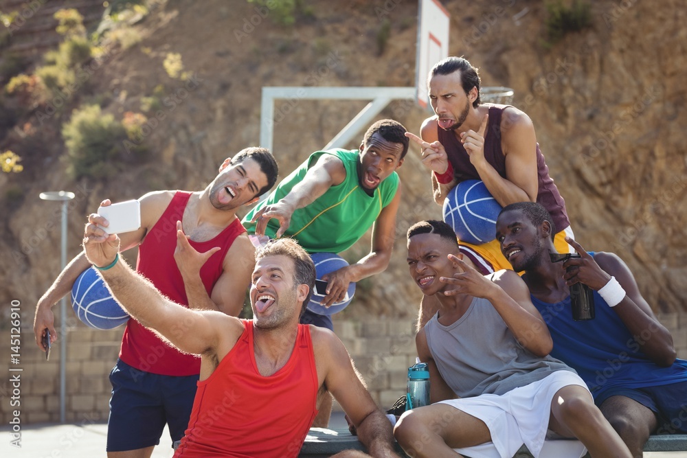 Naklejka premium Basketball players taking a selfie