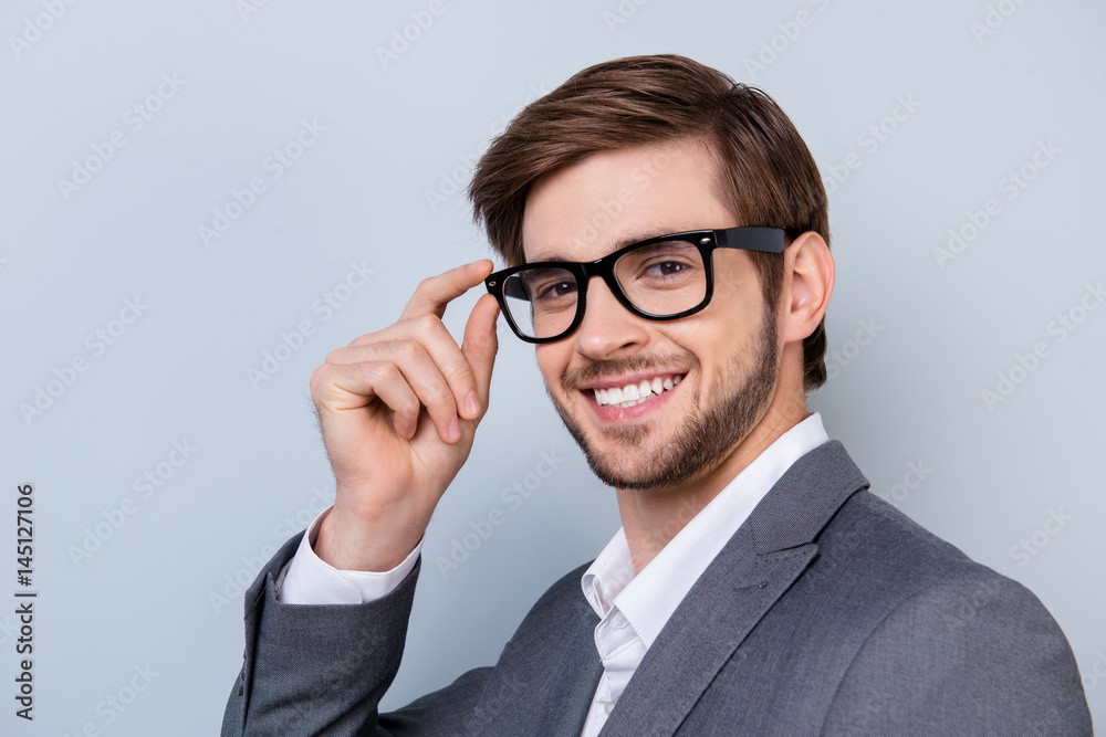Close up portrait of cheerful succesful male in glasses with stunning smile