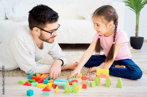 Family playing with toy blocks