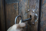 Selective focus vintage keyhole with key on a antique wooden door