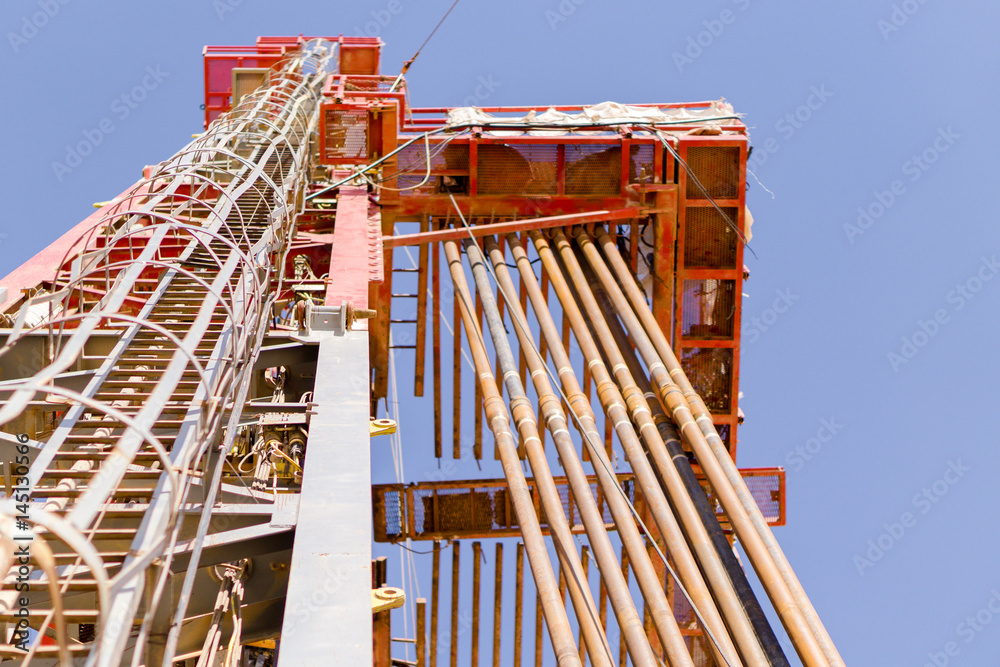 look up view for oil rig mast with drill pipe stands