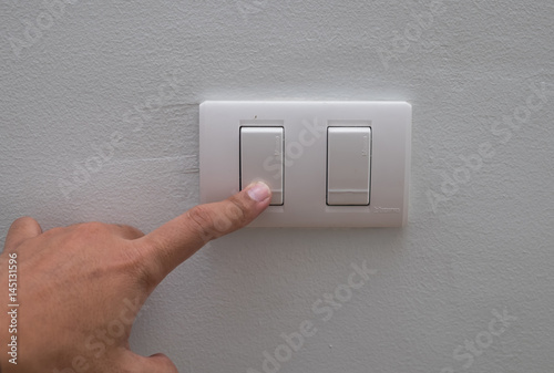 Press the light switch next to the wall.
