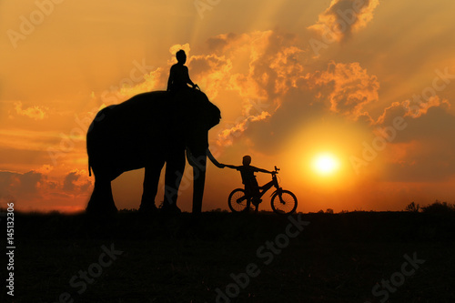 Asian Family Father and son with An elephant silhouette in Thailand.